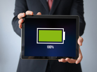 businessman with full battery on a tablet