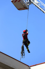 fireman down with the rope in the building during a fire alarm