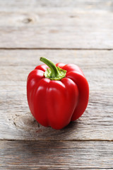 Red pepper on a grey wooden background