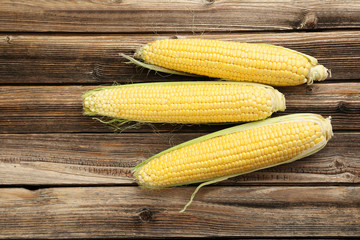 Corns on a brown wooden background