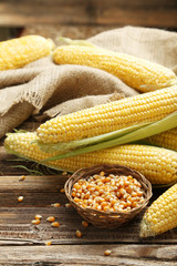 Corns on a brown wooden background