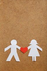 Paper people together in love on the brown background