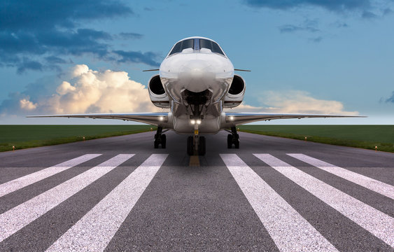 Front view of a private jet on the runway