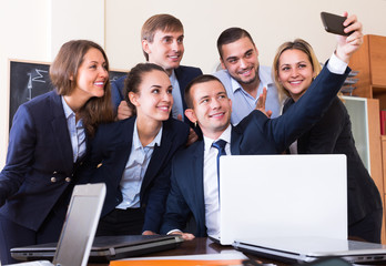 Office workers making selfie together