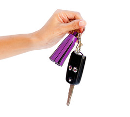 Obraz premium Female hand holding keys isolated on a white