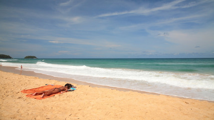 Fototapeta na wymiar Foreign woman got tan on beach in Phuket