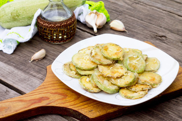 Fried zucchini with garlic in a bowl on a table