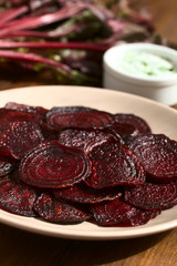 Fresh homemade beetroot chips on plate, photographed with natural light (Selective Focus, Focus one third into the image)