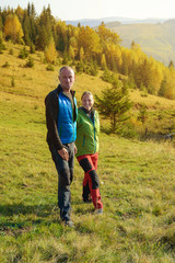 Hikers  are resting  in the autumn mountains.  Happy couple are