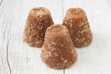 Brown sugar on a rustic white background, Piloncillo mexican