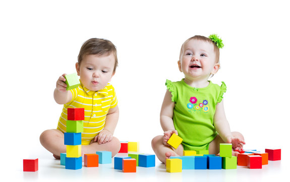 Two adorable kids playing with toys. Toddlers girl and boy