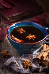 Cup of hot spicy tea with anise and cinnamon, selective focus