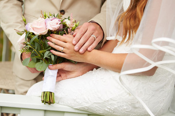 Obraz na płótnie Canvas Close Up Of Couple At Wedding Holding Hands
