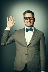 Nerd in eyeglasses and bow tie says Hello