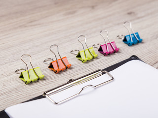 Fototapeta premium colorful paper clip on wood background