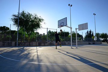 Young playing basketball.
