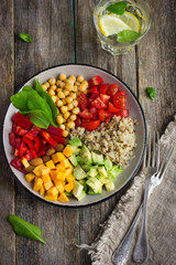 Healthy salad with quinoa, chickpeas, avocado, bell pepper, spin