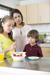 Lovely  Mother and her children having breakfast