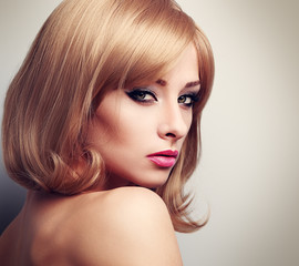 Beautiful female model with fashion blond hairstyle and green ey