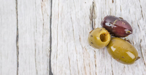 Pickled olive over wooden background