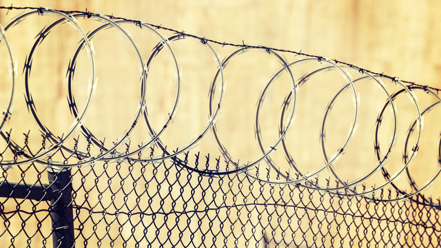 Barbed wire fence, crime and punishment concept photo.