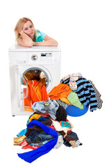 Washing dirty linen on the washing machine. Beautiful girl washes clothes. Isolation. A series of images.