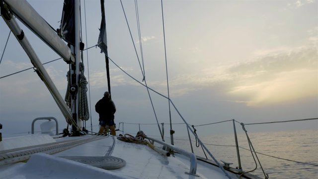 Sailor in the bow of the sailboat while sailing