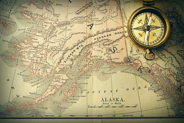 Antique compass over old XIX century map