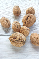 Walnuts on white wooden background
