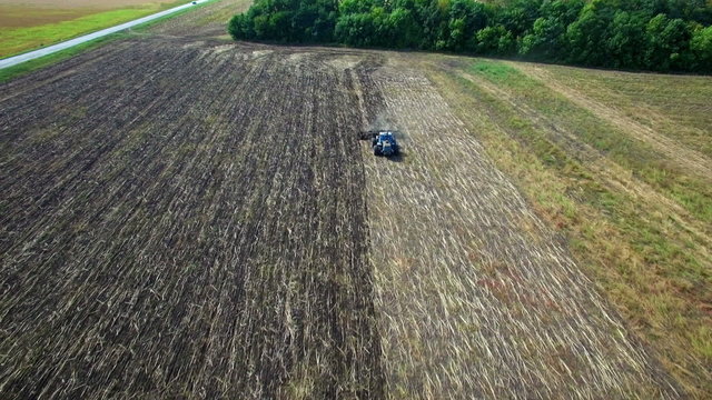 Aerial: Tractor plowing the soil