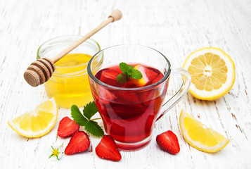 Fruit tea with strawberries, lemon and honey