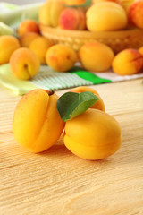 Ripe apricots on wooden table, closeup