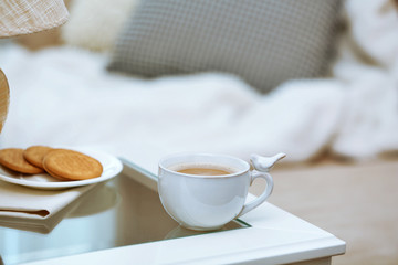 Cup of coffee on table in living room