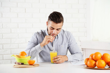 Young man drinking orange juice
