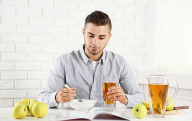 Young man having light breakfast