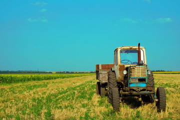 Tractor in field on blue sky background