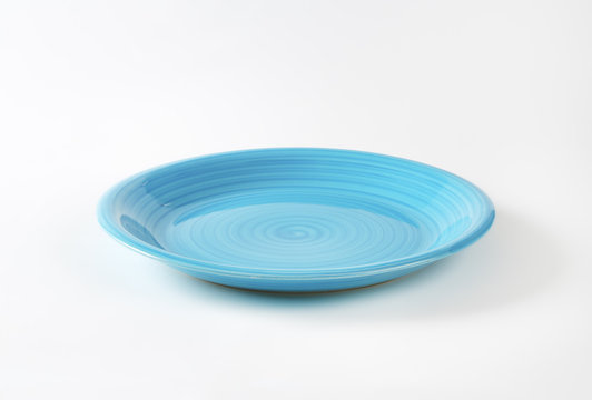 Coupe shaped blue ceramic plate