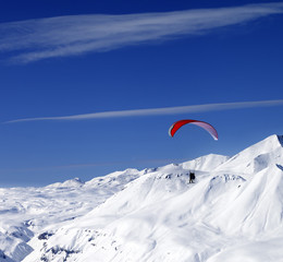 Sky gliding in snowy mountains at nice sun day