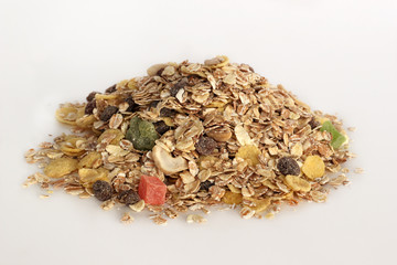 Pile of muesli with fruit and nuts isolated on white background