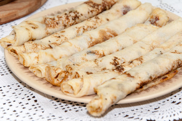 Rolled fresh pancakes on the plate
