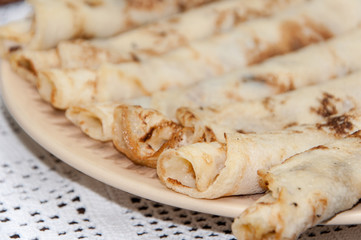 Rolled fresh pancakes on the plate