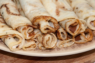 Pancakes stuffed with chocolate cream and served on the plate