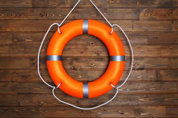 A life buoy on wooden wall