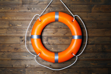 A life buoy on wooden wall