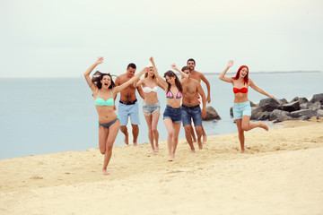 Beautiful young people having fun on beach