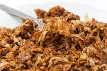 Chinese food chicken meat on the fork in focus