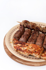 Kebabs and chicken breast on the grill