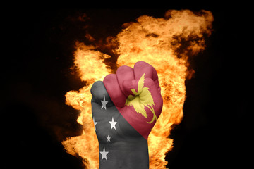 fire fist with the national flag of Papua New Guinea