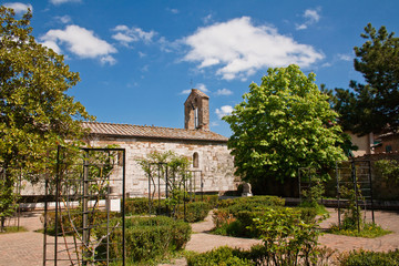 Fototapeta na wymiar Old roman church in garden
