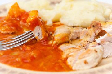 Chicken white meat on the fork in focus